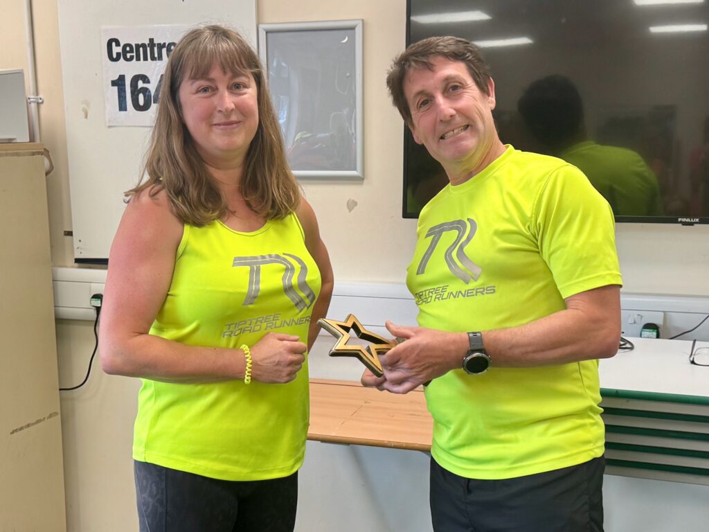Annabel collecting her trophy for winning female Runner of the Month - May 2026